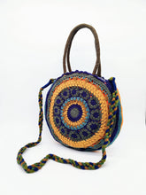 Cargar imagen en el visor de la galería, Bolso redondo de colores de crochet en lana acrílica. Dos asas cortas y otra larga de lana trenzada, de LaNievina. Con asa para banolera